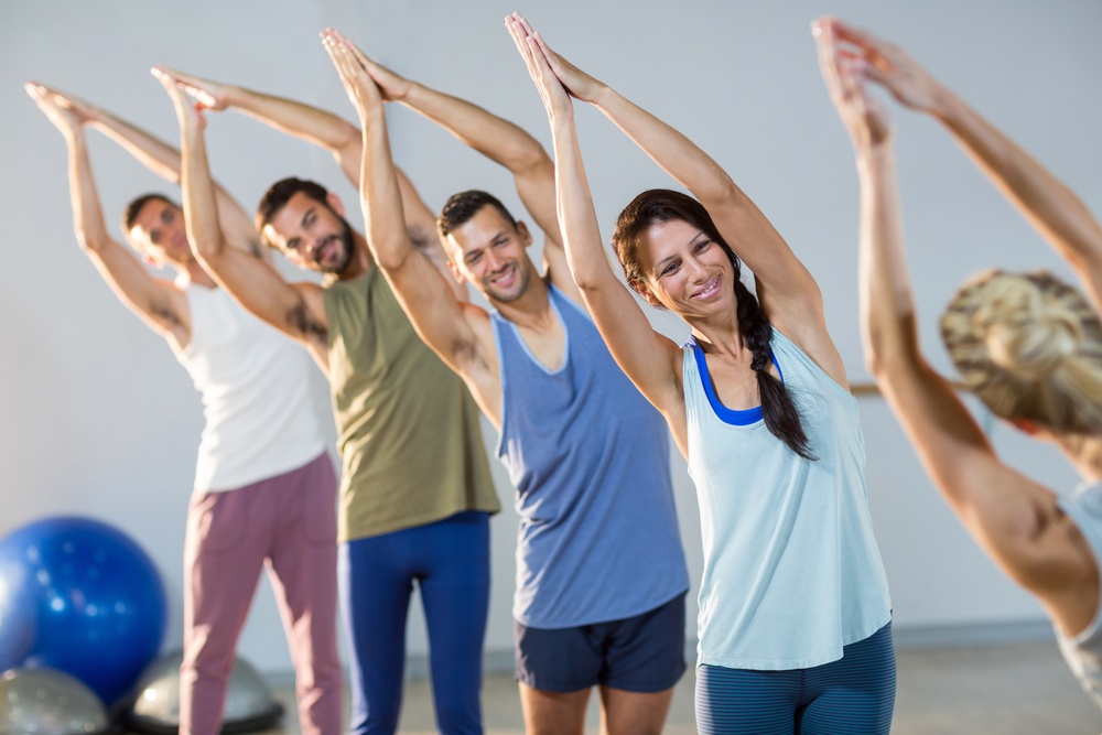 Instructor taking yoga class in fitness studio.jpeg
